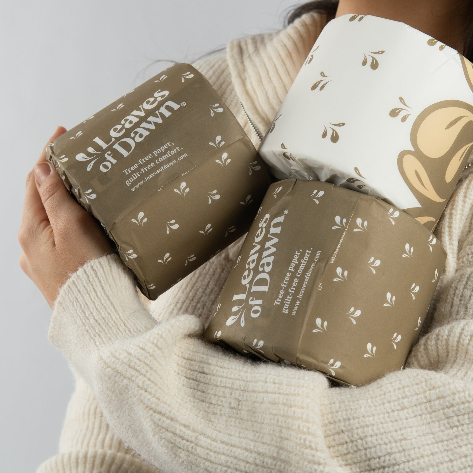 Leaves of Dawn bamboo toilet paper rolls, person holding them.